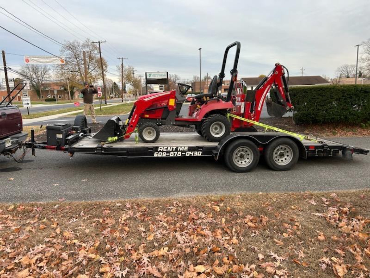Garden State Trailer Rental — compact tractor loaded on the LAMAR deck-over tilt trailer in Hammonton, NJ